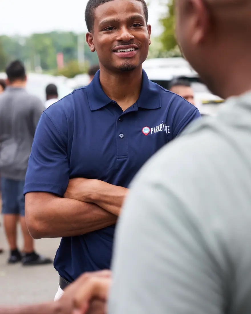 A ParkByPlate team member talking with a property manager on site.